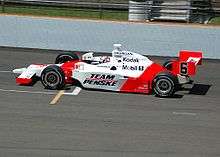 Red-and-white racing car on a track