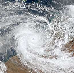 Satellite image of a powerful cyclone near the coast of Western Australia. The storm is very mature, with a large area of deep thunderstorms and a well-defined, clear eye.