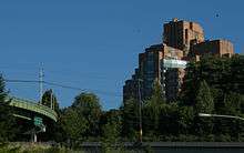 The building on the edge of a wooded hill