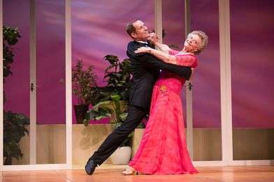 Todd McKenney and Nancye Hayes in a ballroom dancing pose while dancing in a performance of the play Six Dance Lessons in Six Weeks