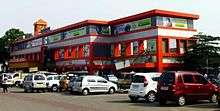 Red-and-white building with cars parked outside