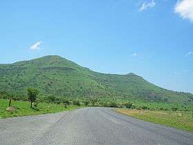 A steep green hill.