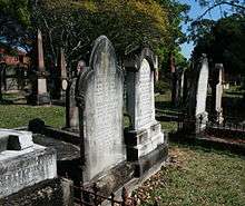 Photograph of gravestones and gothic wrought-ironwork grave boundary fences