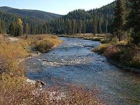 A midsized river flowing through forested hills