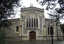 Very large arched window above a large wooden door