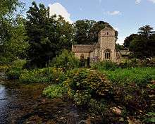 A stone church seen from the River Leach