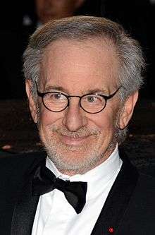 Headshot of a bearded and bespectacled Jewish male wearing a black tuxedo.