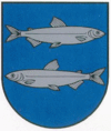 A coat of arms depicting a silver fish swimming to the right on the top and another fish swimming to the left on the bottom all on a blue background