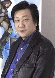 A Japanese man with left-parted hair, a brown leather jacket, and a blue shirt