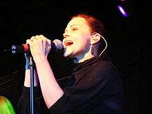 A woman singing into a microphone