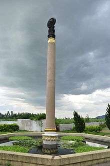 Concrete pillar with dark, decorated top