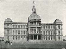 A stately three-story building with a tower on top