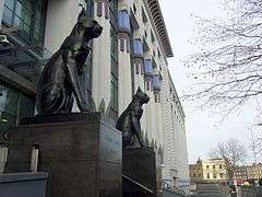 Modern view of the front of the building with two restored black cats