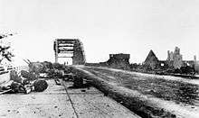 Litter strewn road looking towards bridge