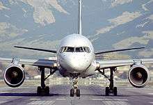 Forward view of aircraft, showing fuselage profile, two circular engines.