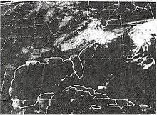 Satellite image of a poorly defined, dissipating tropical cyclone over North Carolina. The image shows a large portion of the United States east of the Rockies and part of Mexico as well as southern Canada. Another, better defined cyclone is visible on the right side of the image.