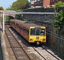 Yellow passenger train at outdoor station