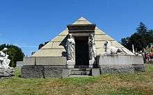 A pyramid, about 3 m tall, with statues