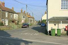 Street scene. Houses to left and right of road junction.