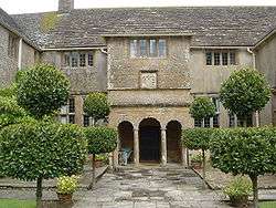 Two-storey house with columns in front of the door.