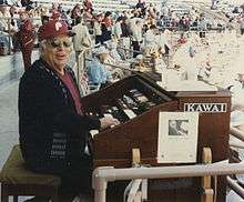 Wilbur Snapp sitting at his organ in Jack Russell Stadium