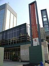 The Francis Winspear Centre for Music with a banner in front for the Edmonton Symphony Orchestra and Century Place tower behind it.