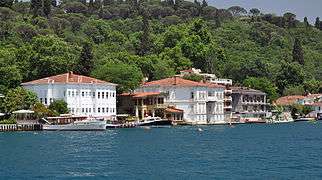 Two- and three-story colored houses with docks and balconies, built directly on the edge of the water