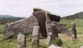 a group of large standing stones in a grassy field