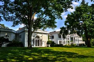 Classically ornate side of a two-story white house